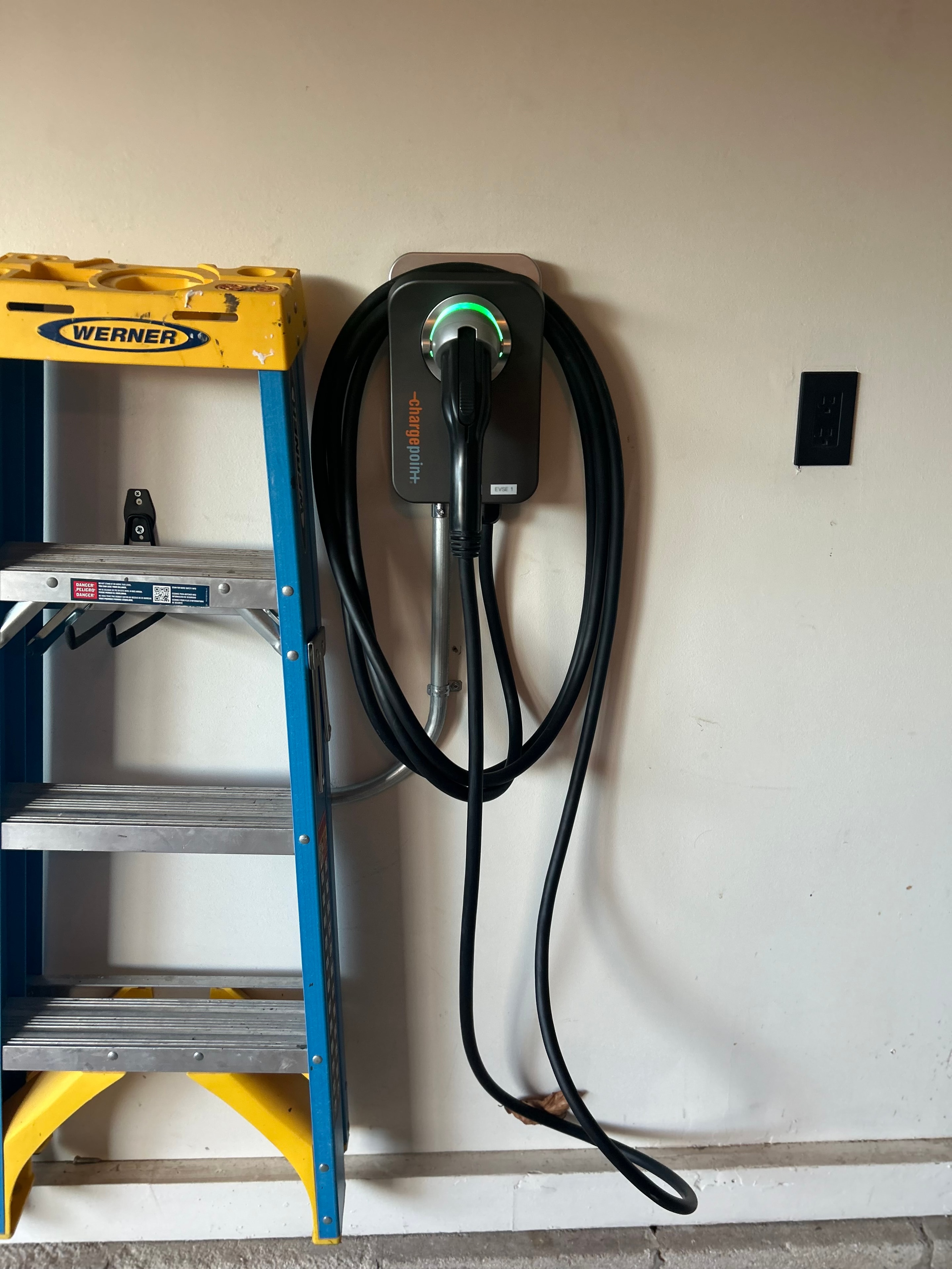 ChargePoint Level 2 EV charger with Werner ladder in residential garage