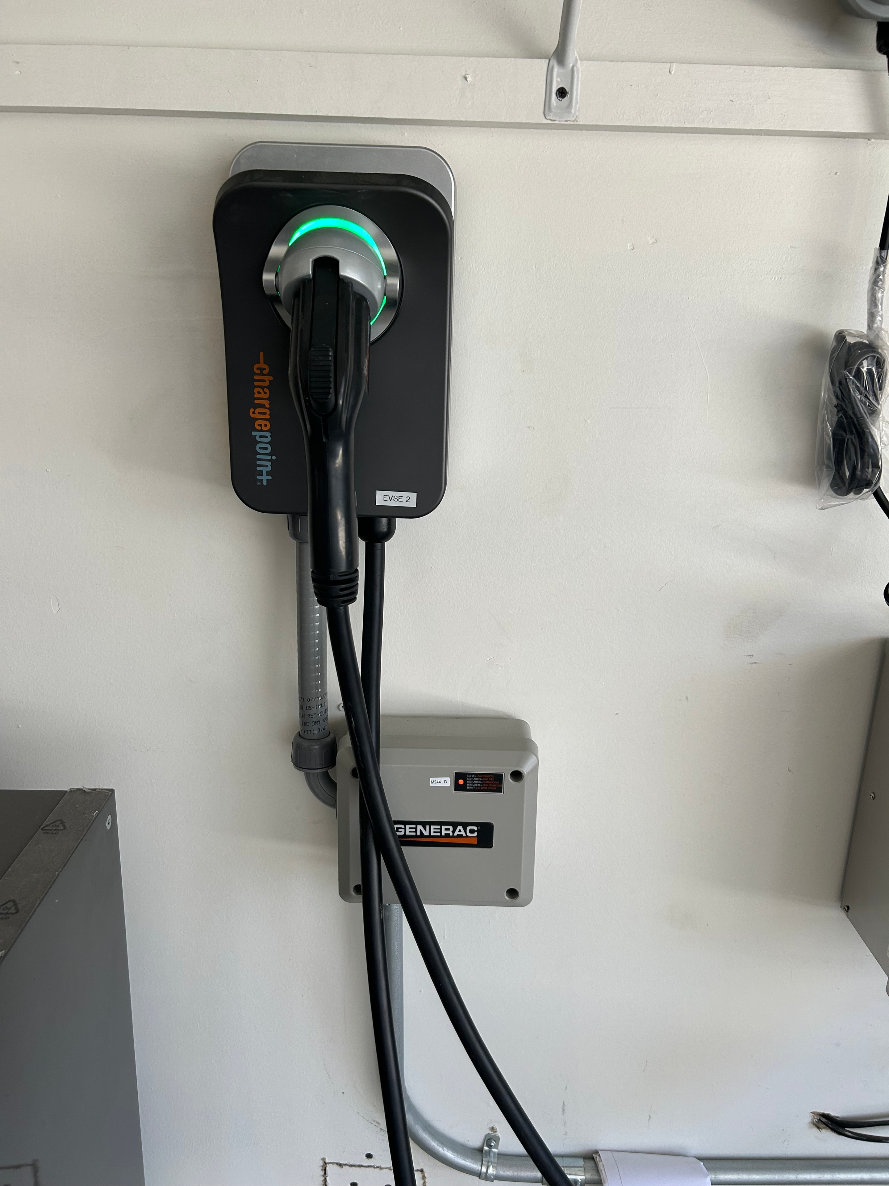 ChargePoint Level 2 EV charger with Generac transfer switch in garage