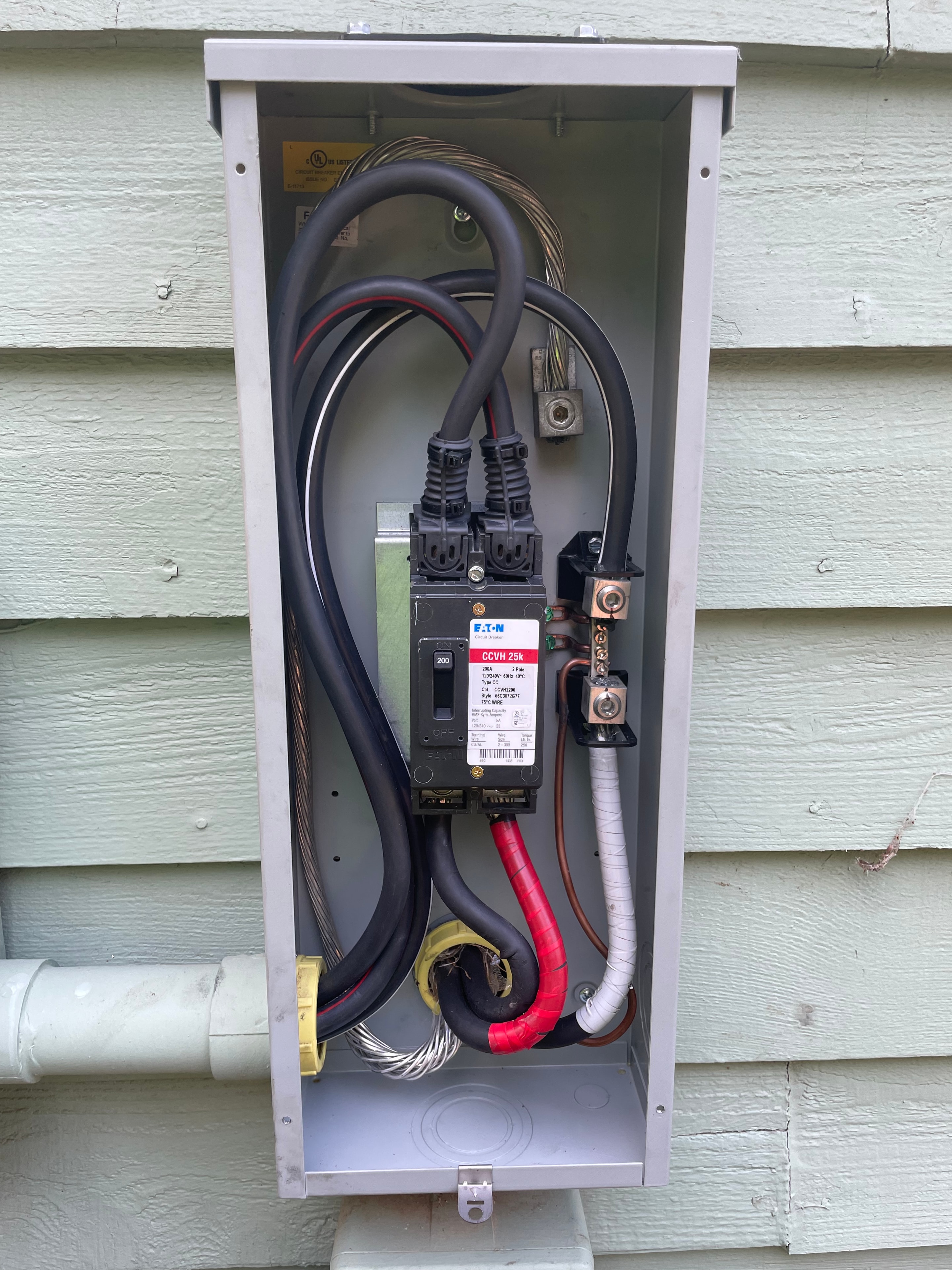 200 amp Eaton service disconnect enclosure mounted on exterior siding